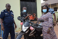 The MP (right) presents a motorbike to the Police