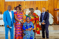 Maame Yaa Tiwaa Addo-Danquah (sitting) and surround by people