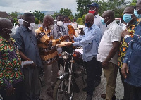 Dr. Adu-Ampomah presenting the motorbikes to the Eastern regional branch of the NPP