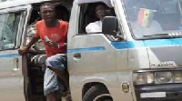 A bus conductor shouting for passengers