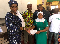 Hajia Zuwera Mohammed Ibrahimah presents stipend to scholarship student