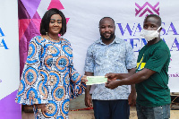 Lawyer Barbara Oteng-Gyasi presenting the cheque