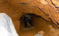 File: The abandoned galamsey pit had been turned into a play swimming pool for kids in the area