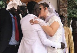 Patapaa kissing his newly weded wife, Liha Miller