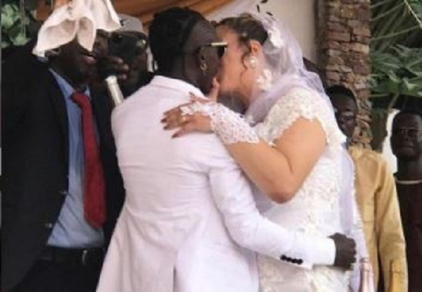 Patapaa kissing his newly weded wife, Liha Miller