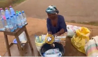 A trader washing bottles (Photo credit: Asaaseradio)