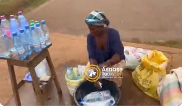 A trader washing bottles (Photo credit: Asaaseradio)