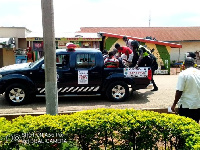 The arrested persons being loaded into the bucket of a police pick up truck