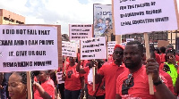 Some demonstrators holding their placards