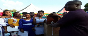 Hon. Amoakohene presenting a sewing machine to one of the beneficiaries