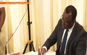 Mr. Whittal signs to accept his appointment at the Flagstaff House