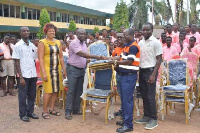 Staff of AngloGold Ashanti Iduapriem donating chairs to FIASEC authorities