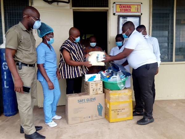 Dr Joseph Appeadido,on the right presenting items to Dr Isaac Secorm  (in smock)