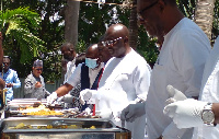 Vice President Dr Mahamudu Bawumia and other officials serving food at his birthday party