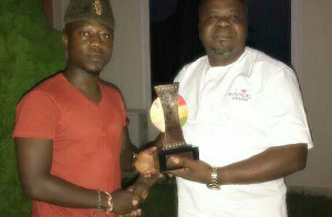 Flowking Stone (left) presenting his award to Dr. Kwaku Oteng