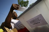 Woman casts her ballot.