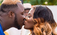 Actress Fella Makfui kissing her husband Medikal at their wedding ceremony held a year ago