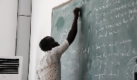 File photo of a teacher writing on a chalkboard