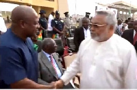 Former President Jerry John Rawlings in a handshake with Former President Mahama