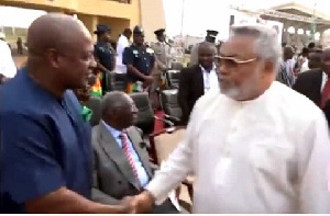 Former President Jerry John Rawlings in a handshake with Former President Mahama