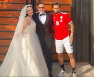 Salah poses with the newlyweds