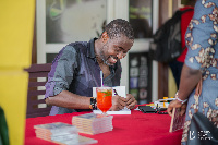 Ace Ankomah signing in his books