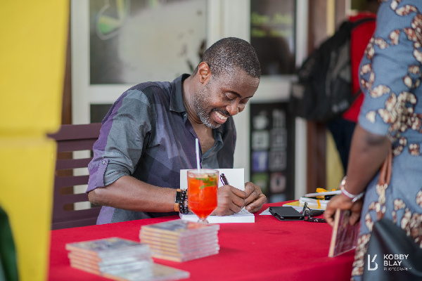 Ace Ankomah signing in his books