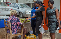 Lydia Seyram Alhassan, MP for Ayawaso West Wuogon giving chocolate to a trader