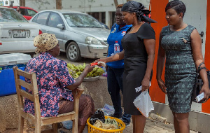 Lydia Seyram Alhassan, MP for Ayawaso West Wuogon giving chocolate to a trader