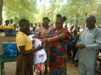 Nadowli-Kaleo DCE, Katherine T. Lankono presents the uniforms to the students