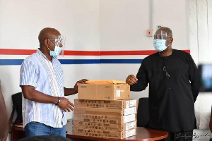 Former Minister of Energy, Boakye Kyeremanteng Agyarko presenting the items to a party executive