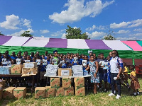 Basic pupils displaying the books donated to them