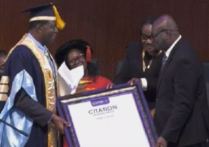 Francis Dadzie [R] receiving the citation