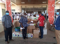 Robert Kwei Blankson, Upper West Zonal Sales Manager of Vodafone, presenting the items to Dr Damien