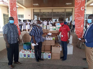 Robert Kwei Blankson, Upper West Zonal Sales Manager of Vodafone, presenting the items to Dr Damien