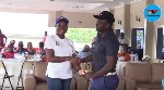 Gifty Appiah presenting a trophy to one of the winners