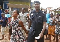 45-year Naana Bray led away by police man.