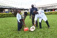 The boy's mother taking the medicine after the drone landed at the hospital