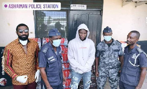 Stonebwoy and his team with some policemen during the presentation