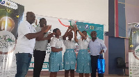 Some students of YASS, displaying the plaque they won at the competition