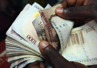 A man counts the Naira, the Nigerian currency