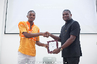 Isaac Younge (left) receiving his award from KC Amese