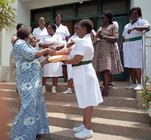 Amanda Cathline presents GHC 20,000.00 cash, to Mrs. Segbefia