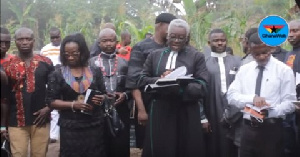 Reverend Crowther Hagan offering prayers for the departed coach