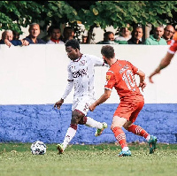 Abdul Rashid Abubakar (in white jersey) attempts to cross the ball