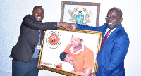 Yahaya Alhassan, presenting a picture to Dr. John Ofori-Tenkorang at SSNIT head office