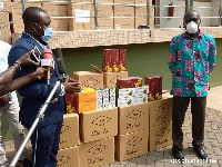 Mr Emilio Okyere-Dadzie presenting some health products to Dr Anthony Ofosu