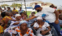 CEO of McDan Group of Companies, Mr Daniel McKorley with a section of the widows