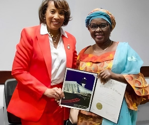 Chair Randall (left) Presenting The Honorary Citizenship Certificate To Ambassador Alima Mahama