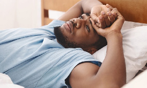 Black Man Laying In Bed 